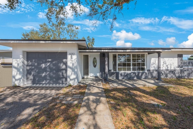 ranch-style home featuring a garage