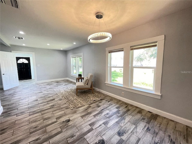 unfurnished room with hardwood / wood-style flooring