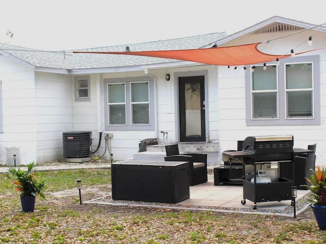 exterior space with a patio area, an outdoor hangout area, and central AC