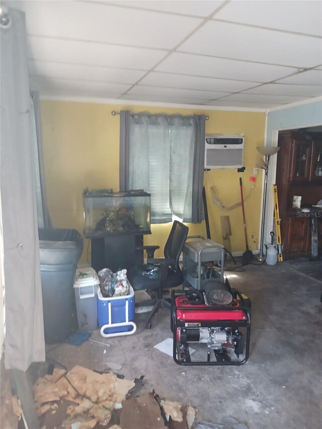 321 77th Ave, St Pete Beach, FL 33706 - living room featuring an AC wall unit and unfinished concrete flooring