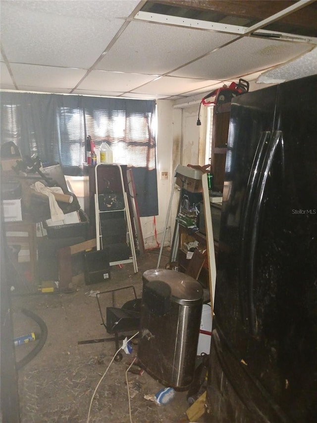 321 77th Ave, St Pete Beach, FL 33706 - basement with a paneled ceiling and freestanding refrigerator
