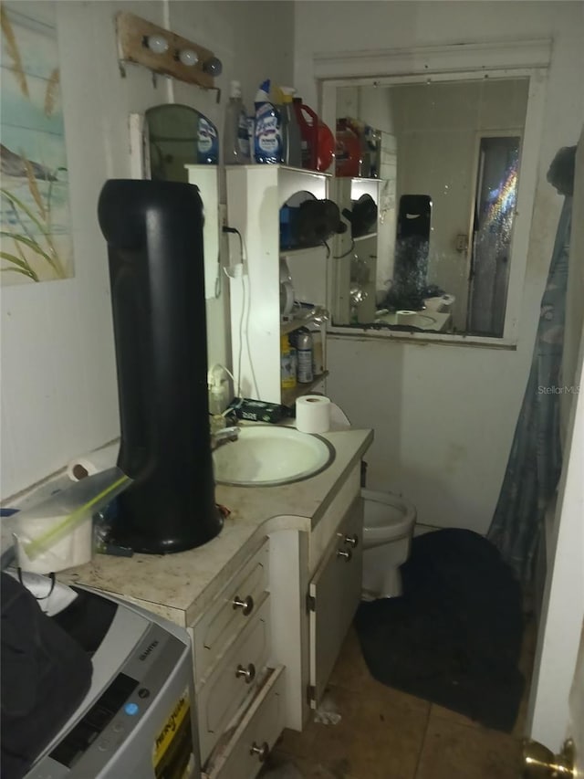 bathroom with tile patterned flooring, vanity, and toilet