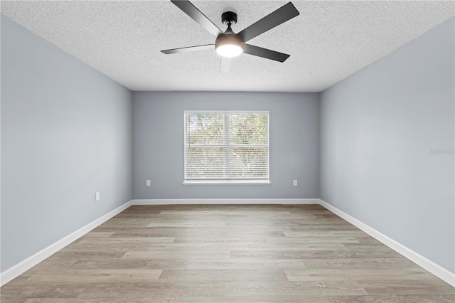 empty room with ceiling fan, light hardwood / wood-style floors, and a textured ceiling