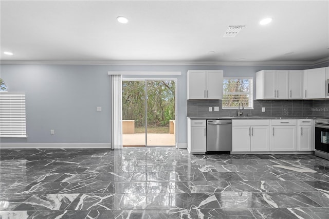 kitchen featuring backsplash, white cabinetry, stainless steel appliances, and a wealth of natural light