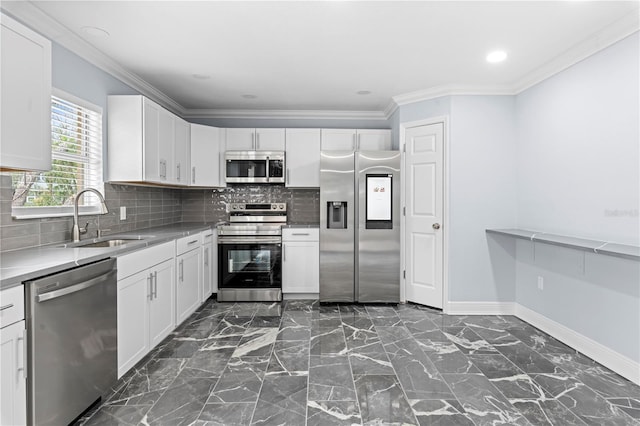 kitchen with decorative backsplash, appliances with stainless steel finishes, white cabinetry, and sink