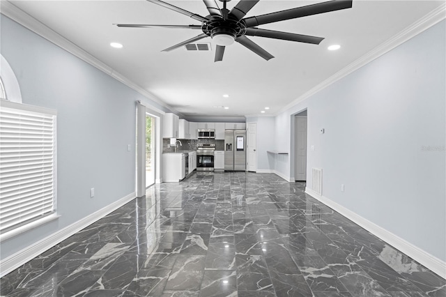 unfurnished living room featuring ceiling fan, ornamental molding, and sink