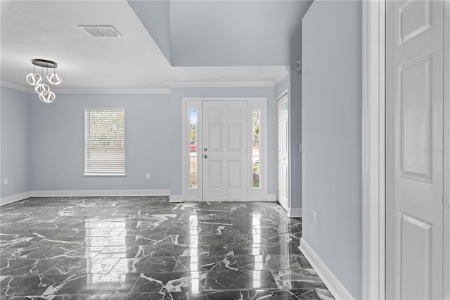 foyer with a healthy amount of sunlight and ornamental molding