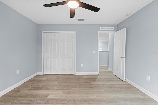 unfurnished bedroom with a closet, ceiling fan, and light hardwood / wood-style flooring