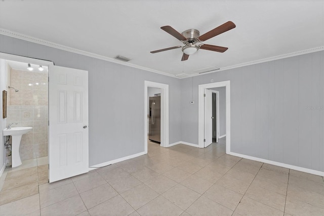 tiled empty room with ceiling fan, ornamental molding, and sink