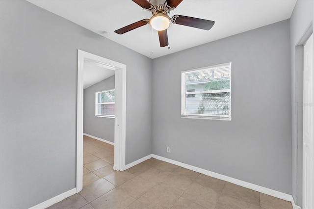 unfurnished room with ceiling fan, light tile patterned flooring, and lofted ceiling