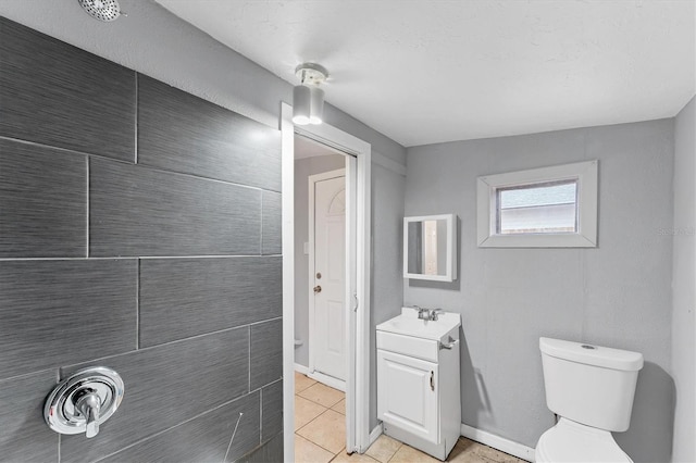 bathroom featuring tile patterned flooring, vanity, and toilet