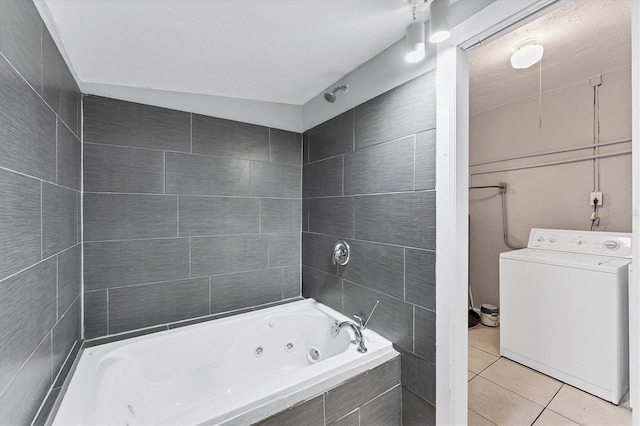 bathroom with tile patterned floors, washer / clothes dryer, and tiled bath