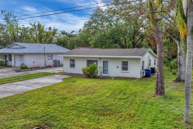 ranch-style home with a front lawn and cooling unit