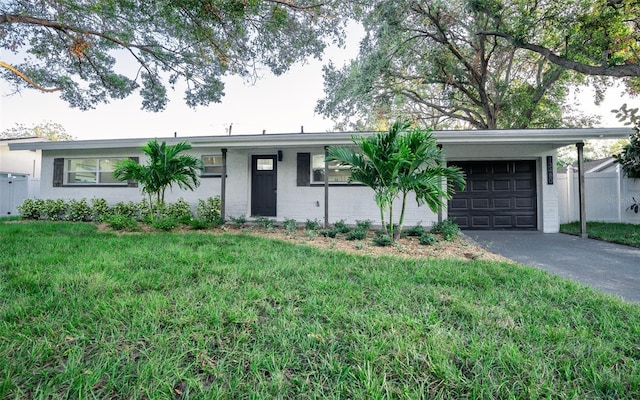 ranch-style house featuring a carport and a front lawn