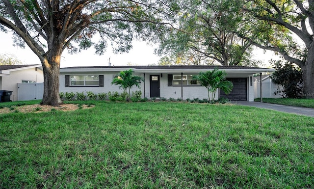 ranch-style house with a garage and a front yard