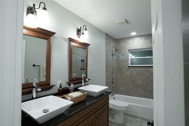 full bathroom with vanity, toilet, and tiled shower / bath