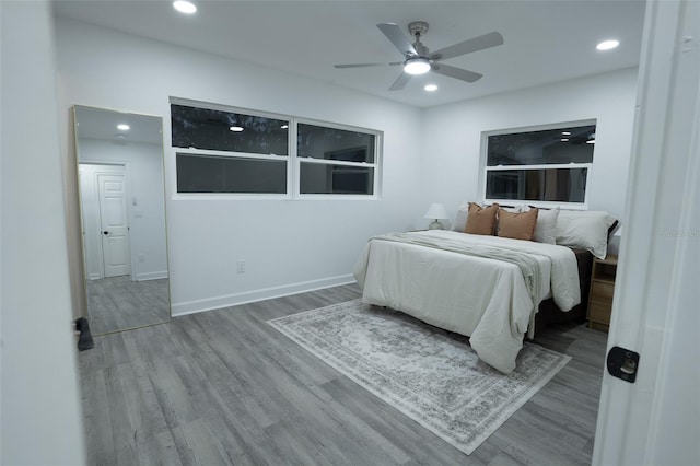 bedroom with wood-type flooring and ceiling fan