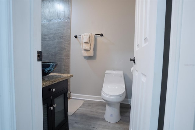 bathroom featuring hardwood / wood-style floors, vanity, and toilet