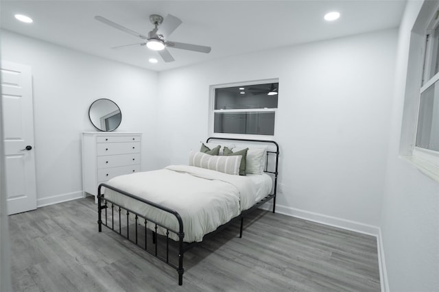 bedroom with ceiling fan and wood-type flooring