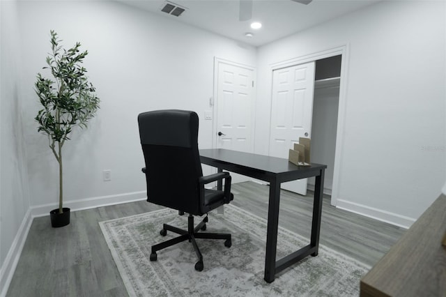 home office with dark hardwood / wood-style floors