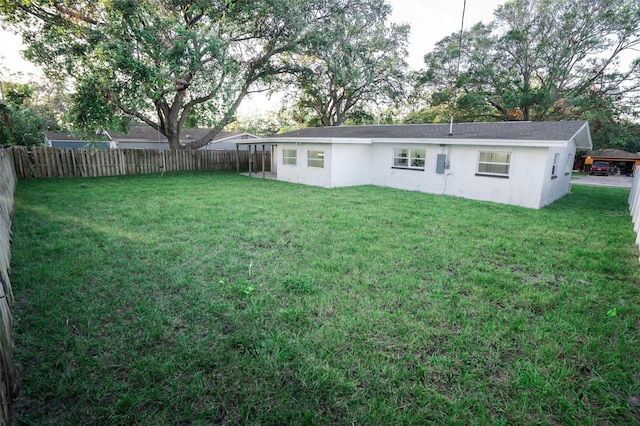 rear view of property with a lawn