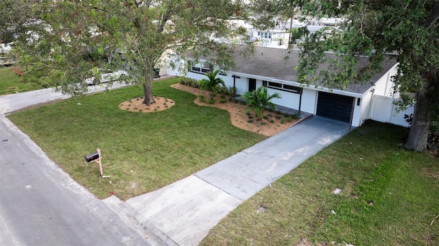 view of front of property featuring a front yard and a garage