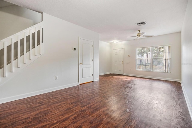 unfurnished living room featuring a textured ceiling, ceiling fan, and dark hardwood / wood-style floors