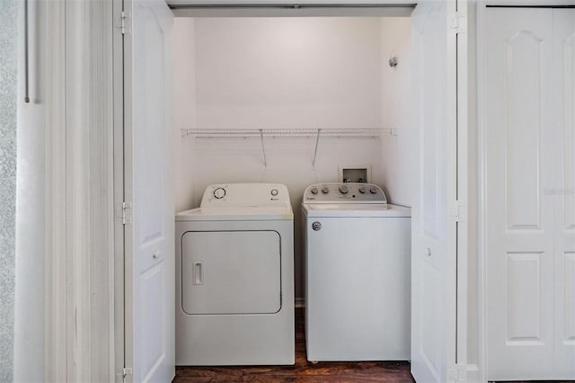 laundry area featuring washing machine and dryer and dark hardwood / wood-style floors