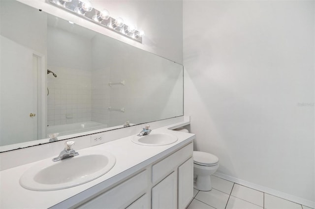 full bathroom featuring tile patterned floors, toilet, vanity, and tiled shower / bath