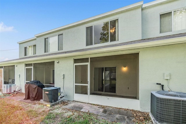 back of house with central AC unit