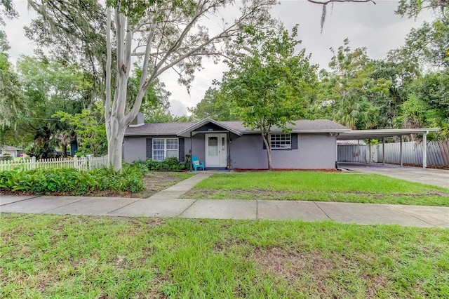 ranch-style house featuring a front yard and a carport