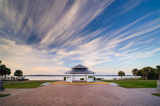 view of home's community with a gazebo, a yard, and a water view