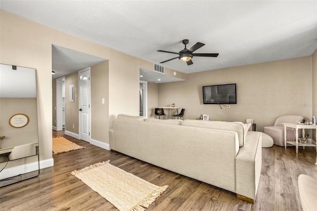 living room with ceiling fan and hardwood / wood-style floors