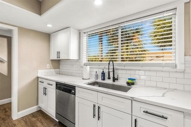 kitchen with decorative backsplash, white cabinets, dark wood-type flooring, sink, and dishwasher