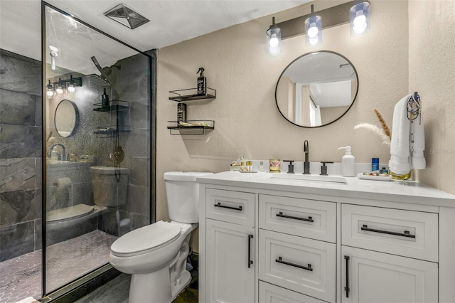 bathroom featuring a shower with door, vanity, and toilet