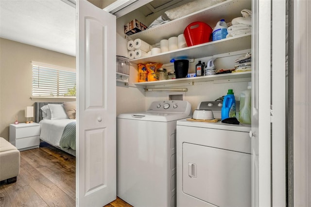 washroom featuring separate washer and dryer and light hardwood / wood-style floors