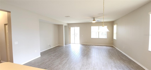 spare room with hardwood / wood-style flooring and ceiling fan