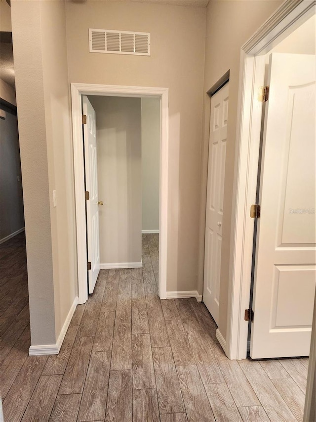 corridor with light hardwood / wood-style flooring