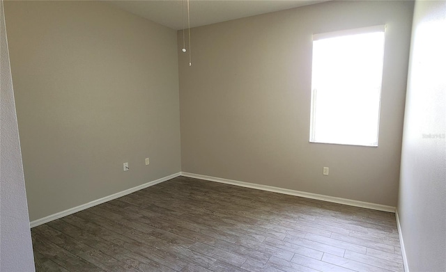 spare room featuring dark hardwood / wood-style flooring