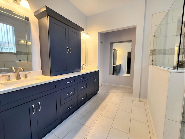 bathroom with tile patterned floors, vanity, and tiled shower