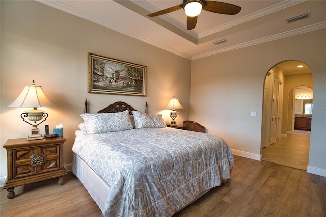 bedroom with hardwood / wood-style flooring, ceiling fan, and ornamental molding