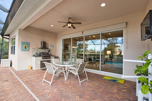 view of patio with ceiling fan, an outdoor kitchen, and grilling area