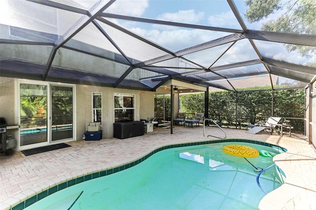 view of swimming pool featuring glass enclosure and a patio area