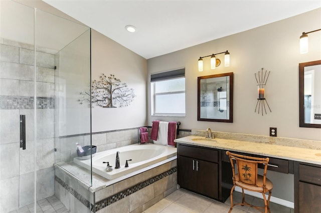 bathroom with tile patterned floors, vanity, and separate shower and tub