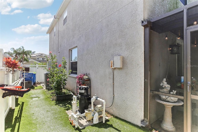 view of side of home with a yard