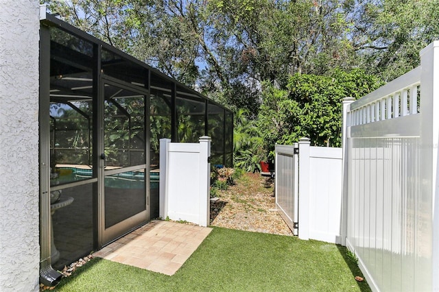 view of yard featuring glass enclosure and a swimming pool