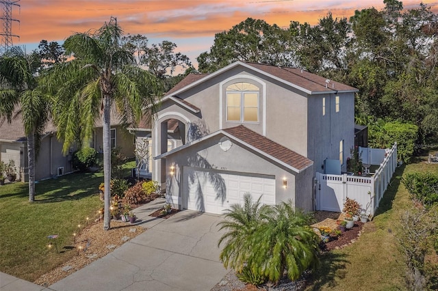 view of front of house featuring a yard and a garage