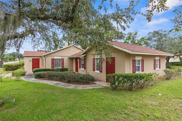 ranch-style home with a front lawn