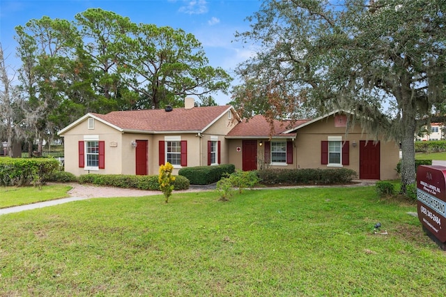 ranch-style home featuring a front yard