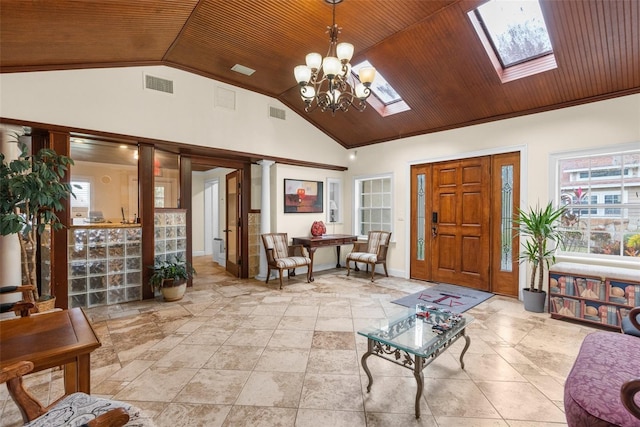 entrance foyer with a notable chandelier, wooden ceiling, high vaulted ceiling, and a skylight